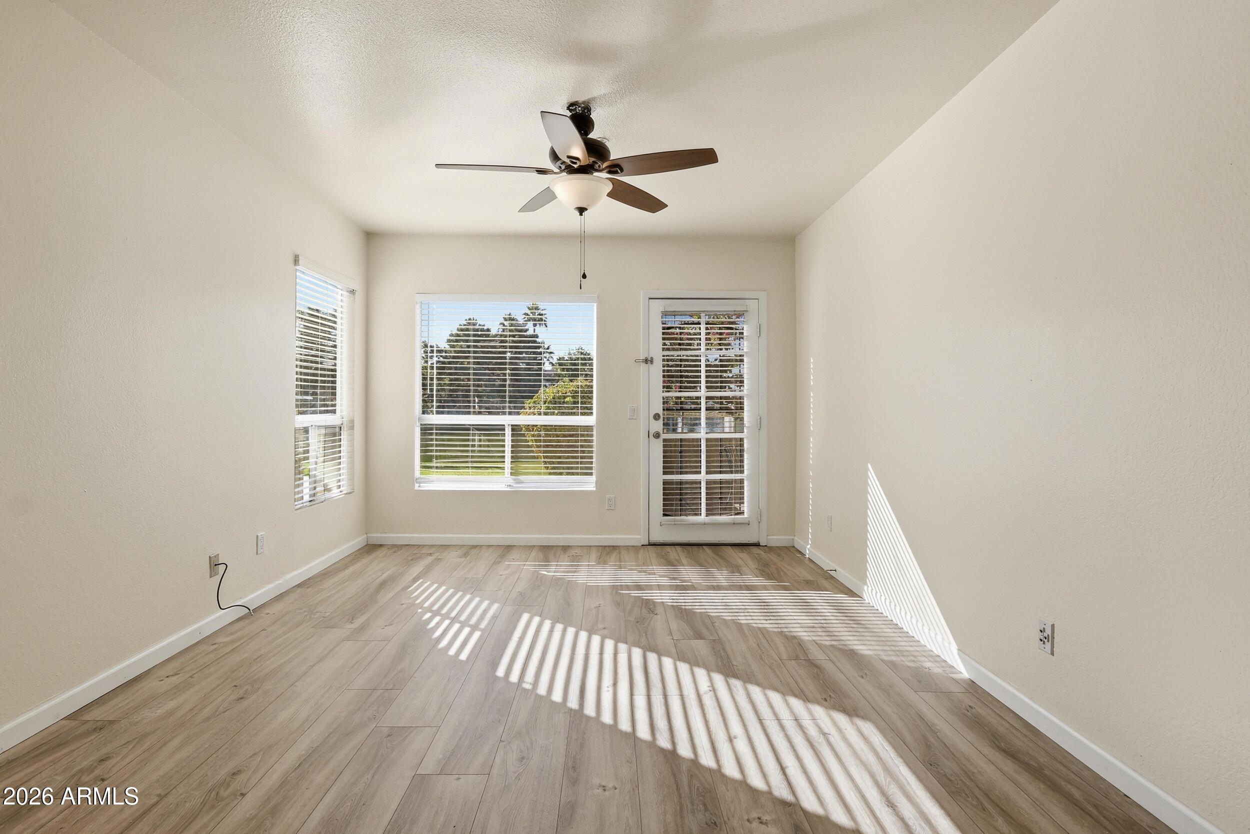 1825 West Ray Road, Unit 1018 Chandler, AZ 85224 - Photo 22 of 46 a view of empty room with wooden floor and fan