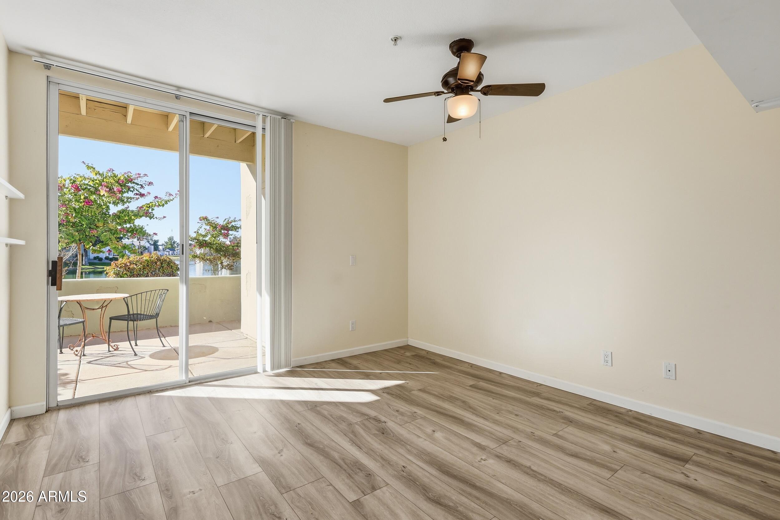 1825 West Ray Road, Unit 1018 Chandler, AZ 85224 - Photo 23 of 46 a view of empty room with wooden floor and fan