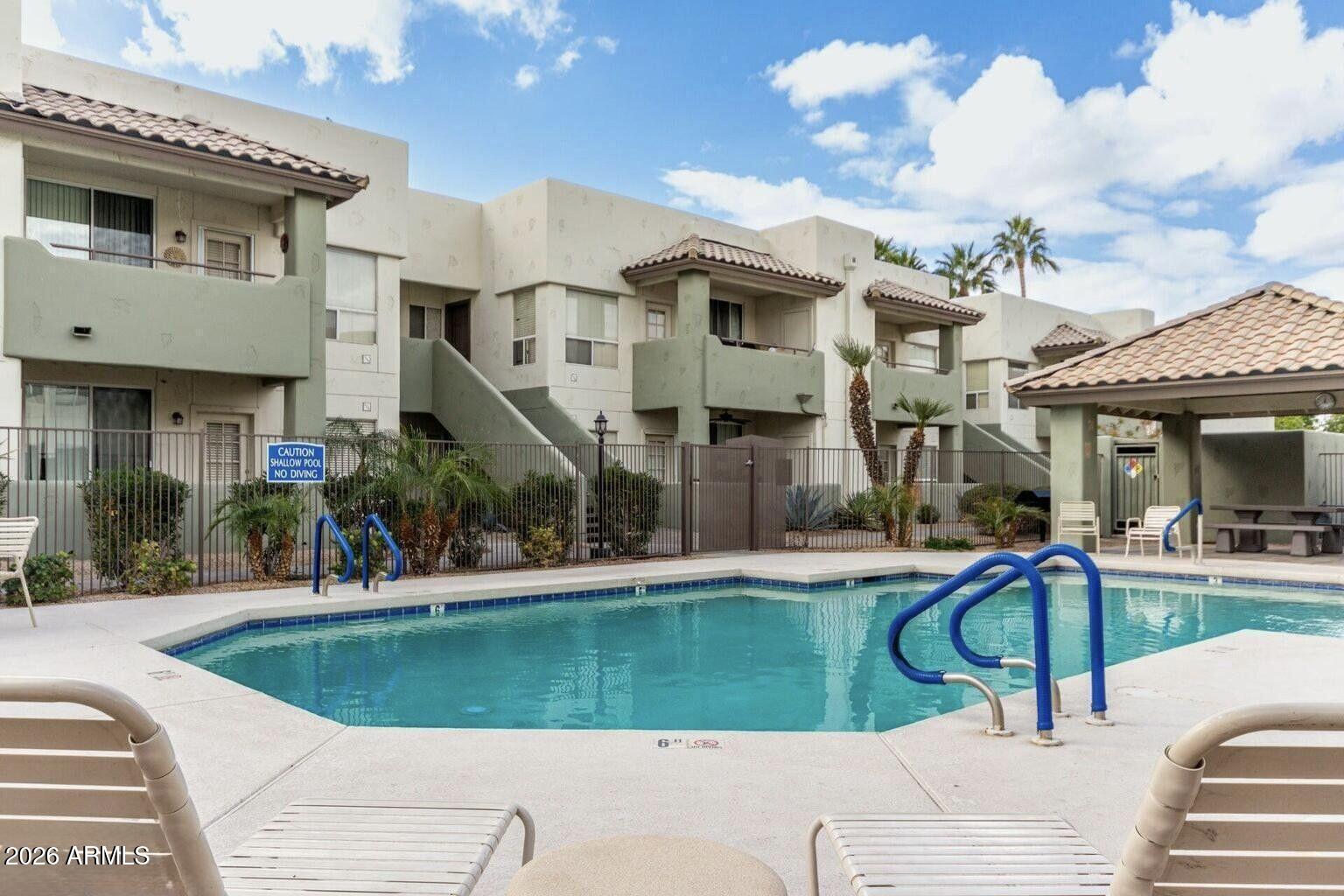 1825 West Ray Road, Unit 1018 Chandler, AZ 85224 - Photo 27 of 46 a view of a house with swimming pool and sitting area