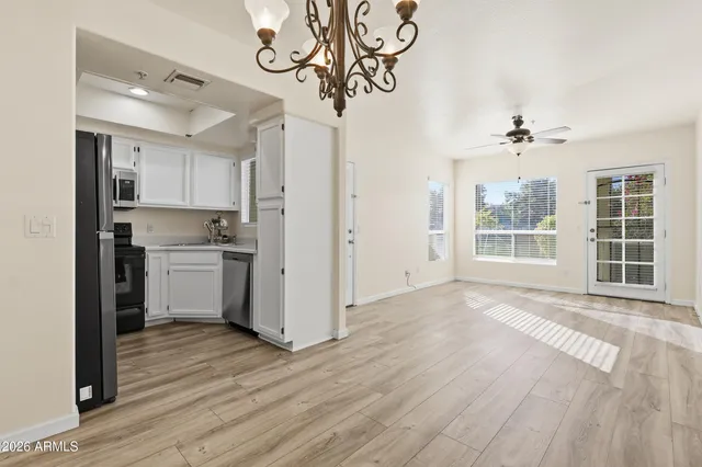 a kitchen with white cabinets and a sink