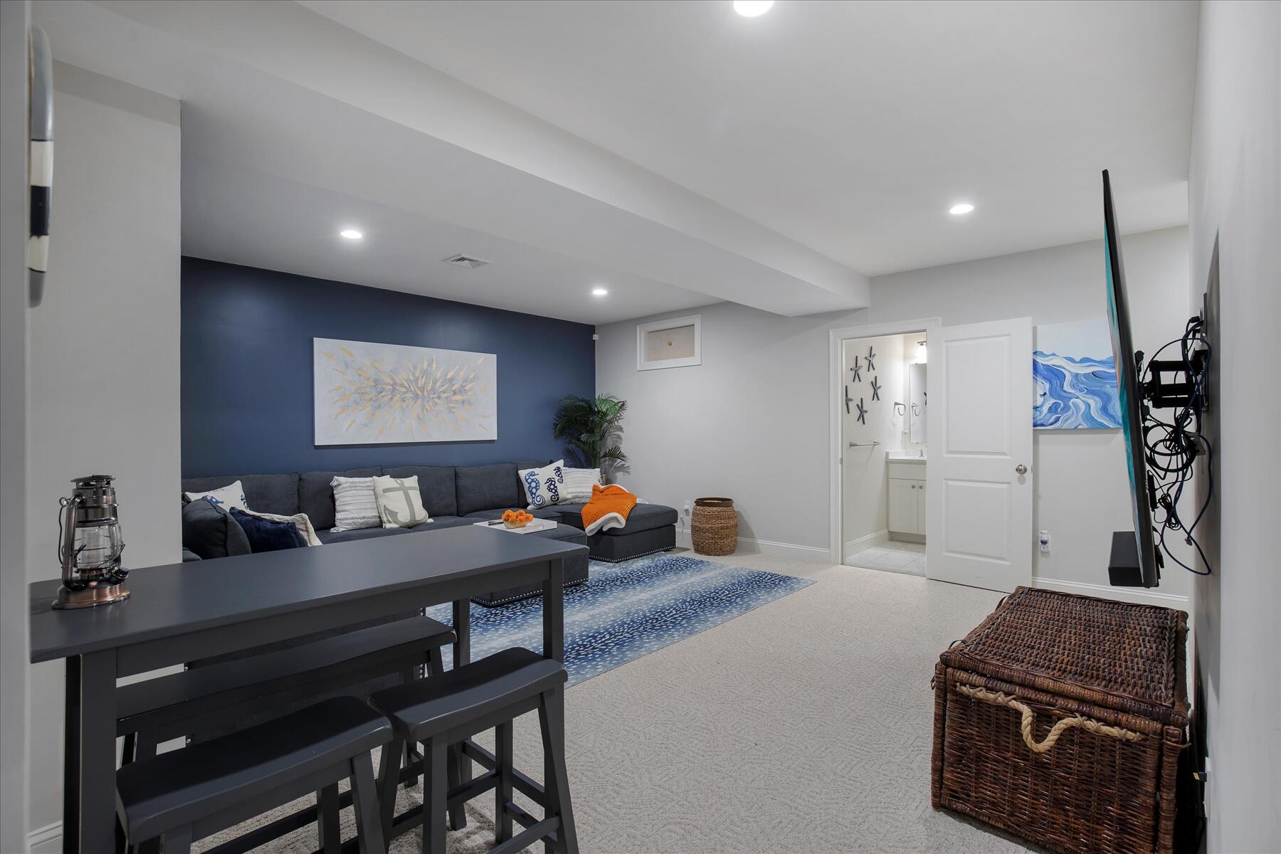 21 Saltwater Circle Mashpee, MA 02649 - Photo 20 of 40 a living room with furniture a flat screen tv and a refrigerator