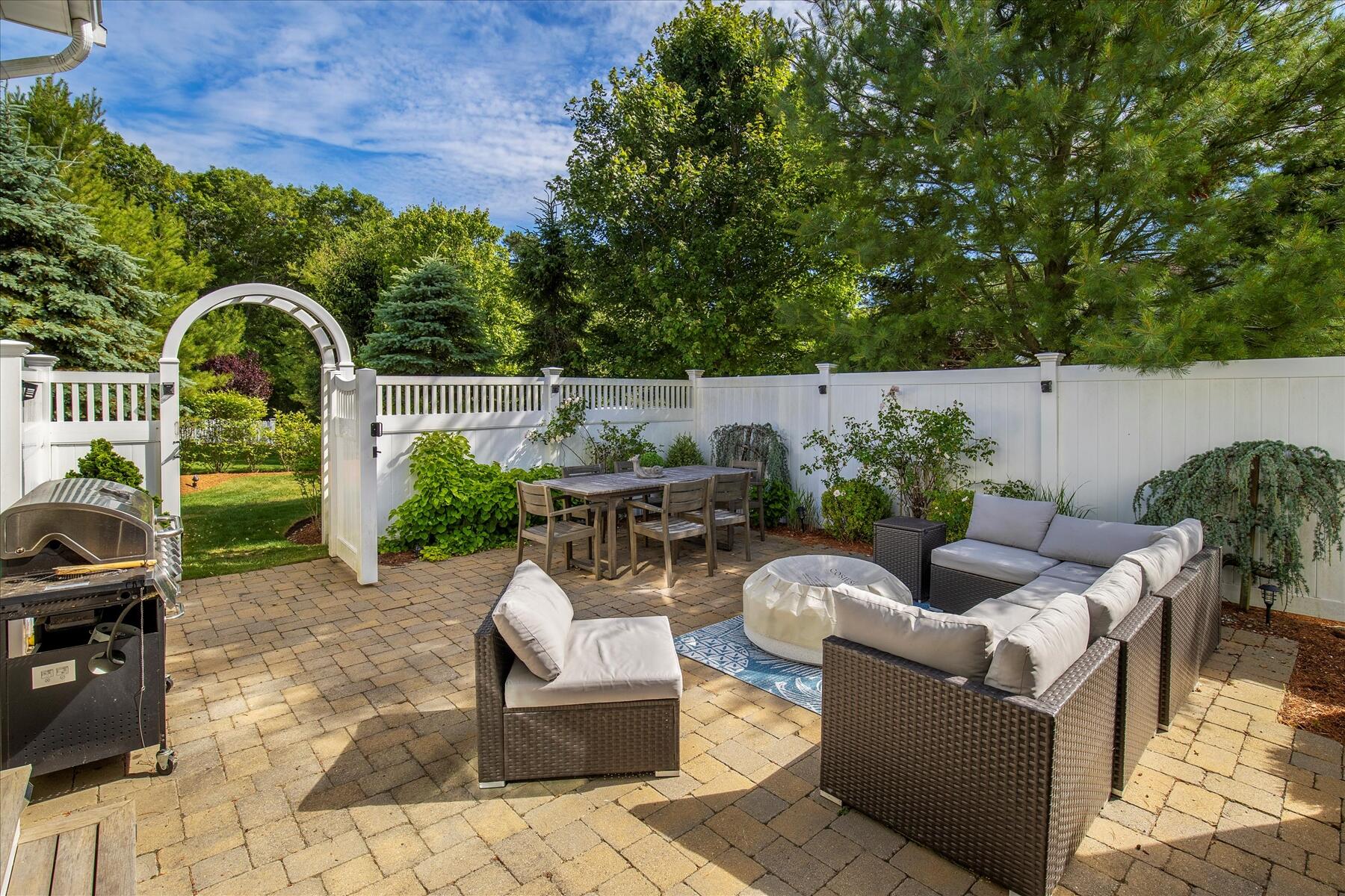 21 Saltwater Circle Mashpee, MA 02649 - Photo 2 of 40 a view of a patio with couches a table and chairs and potted plants