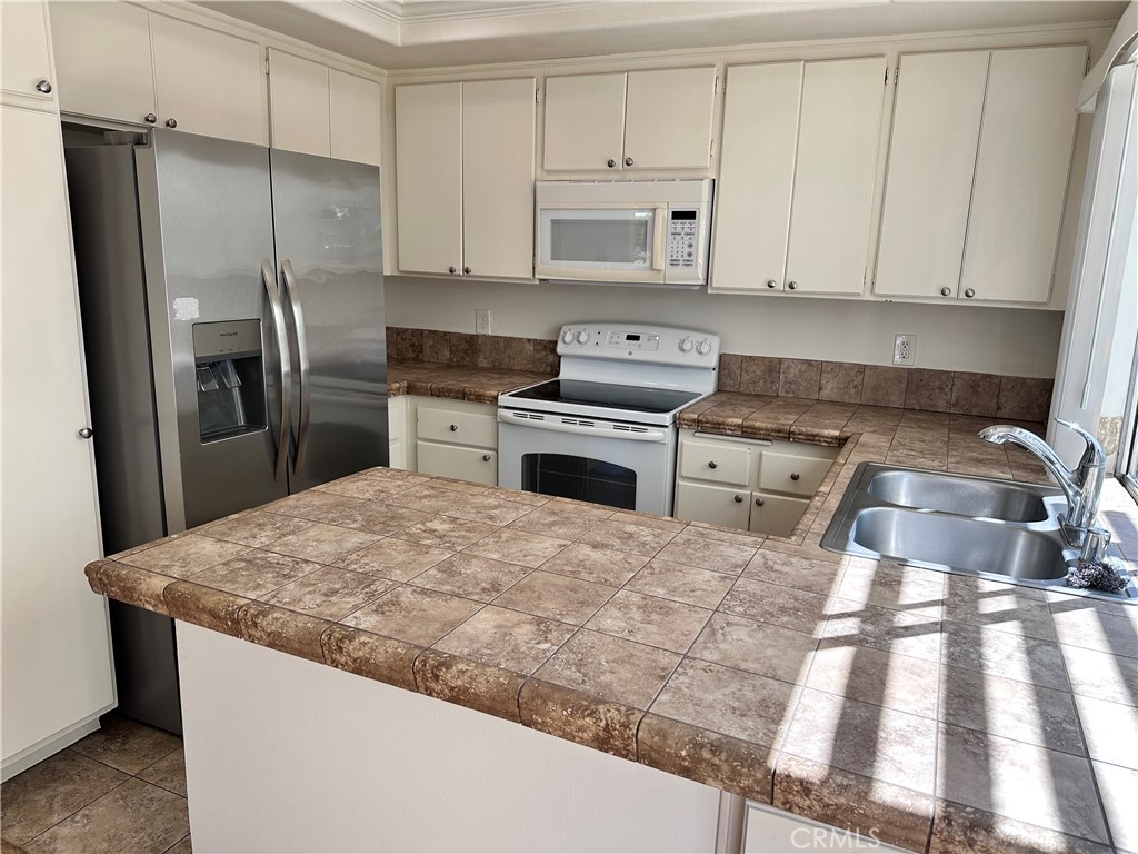 1 Sunflower Irvine, CA 92604 - Photo 8 of 19 a kitchen with granite countertop a refrigerator sink and stove