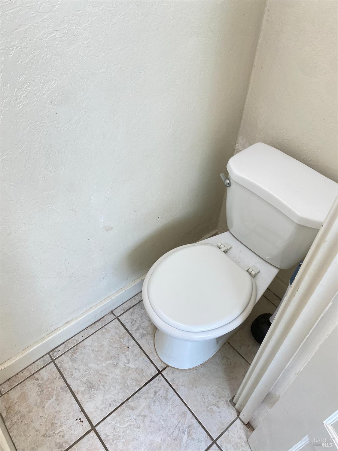 745 Jackson Street Fairfield, CA 94533 - Photo 55 of 72 a white toilet sitting next to a white wall
