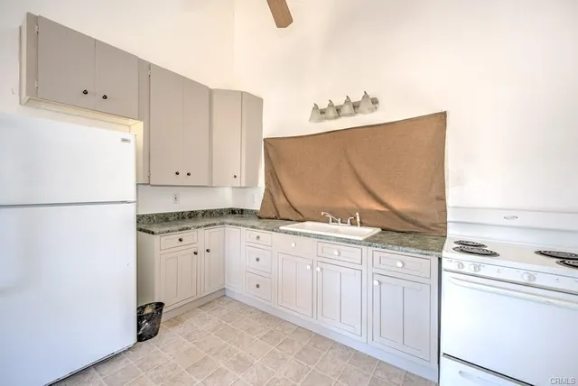 a view of a house with a yard and roof