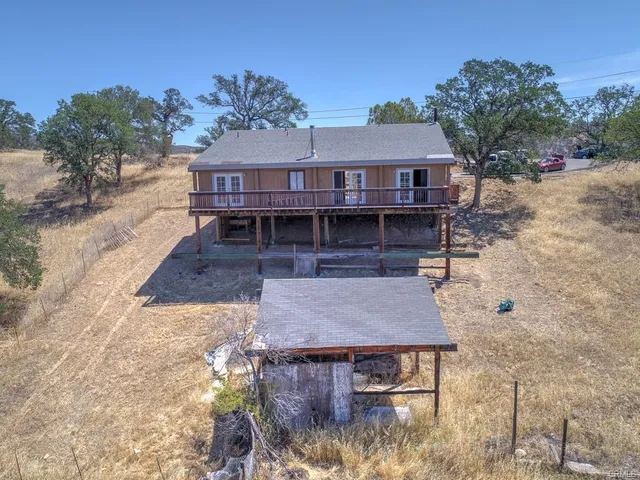 a view of a roof deck with wooden fence and a floor