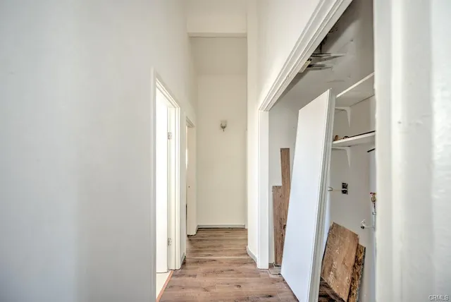 a view of a hallway with wooden floor and staircase