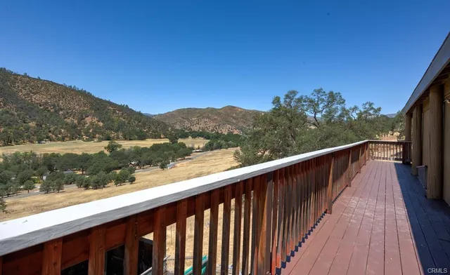 a view of balcony with wooden floor and lake view