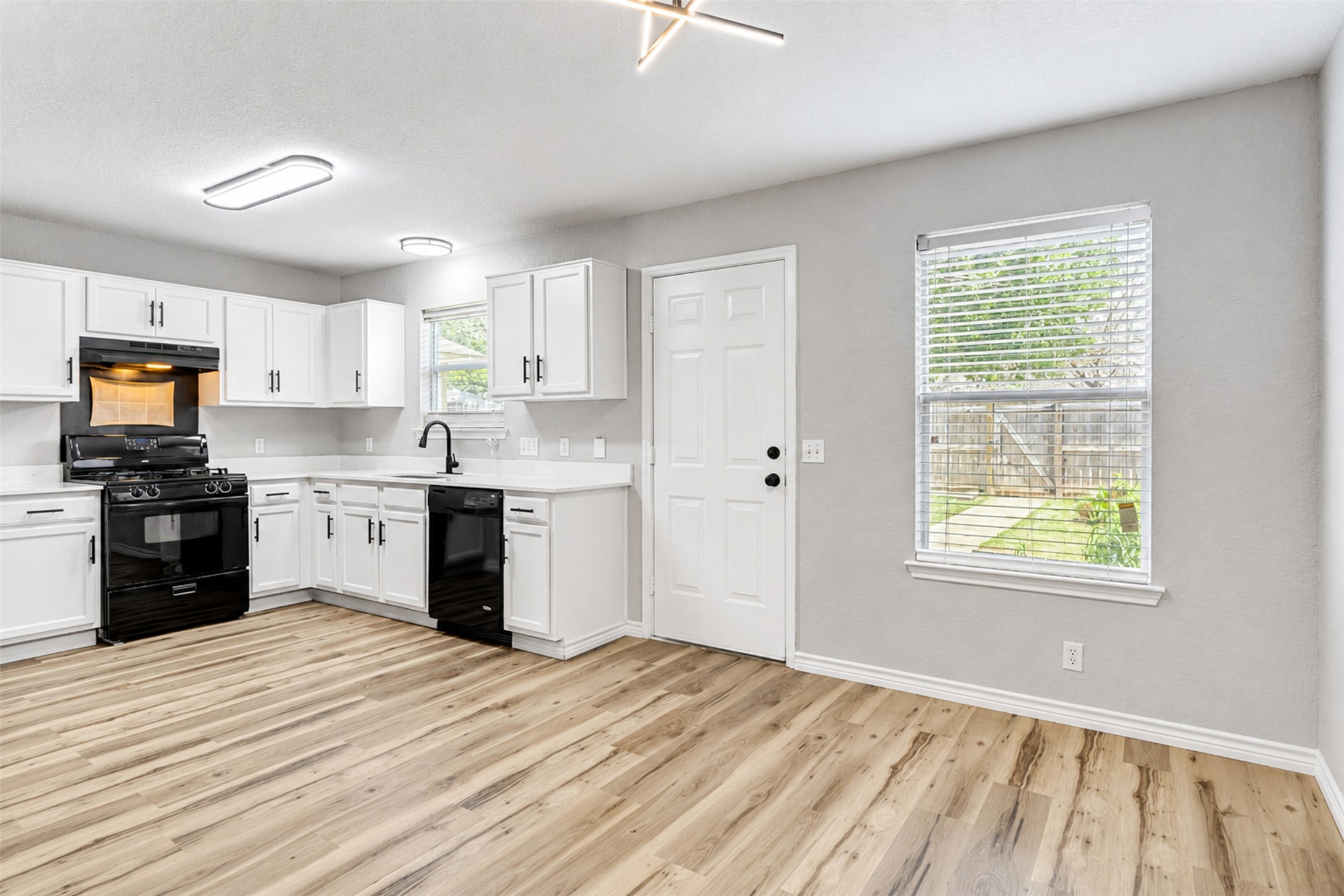 4523 Secure Lane Austin, TX 78725 - Photo 12 of 40 A well-equipped culinary space boasts black appliances and a convenient layout.