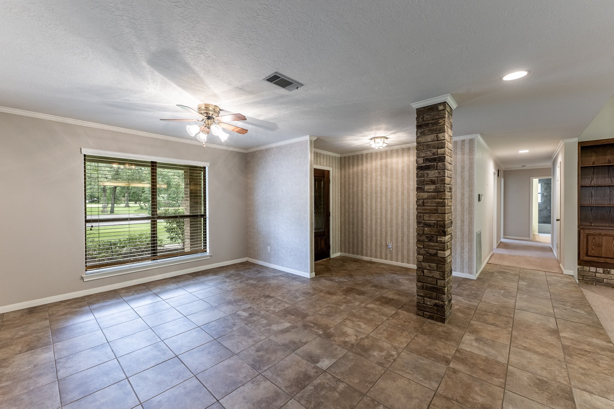 104 Oakview Circle Huntsville, TX 77340 - Photo 5 of 36 a view of an empty room with a window