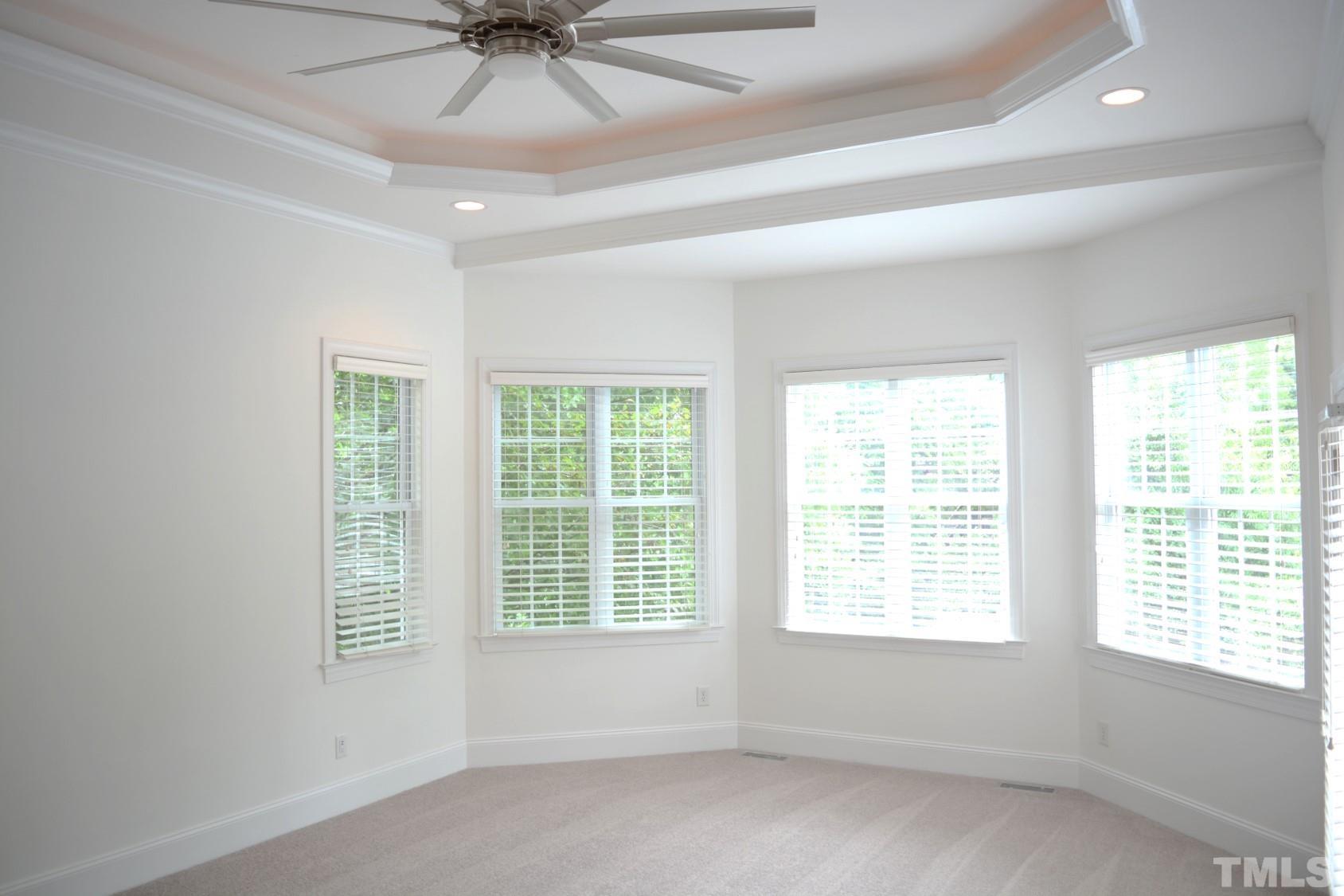 1322 Medfield Road Raleigh, NC 27607 - Photo 18 of 25 a big room with windows and chandelier fan