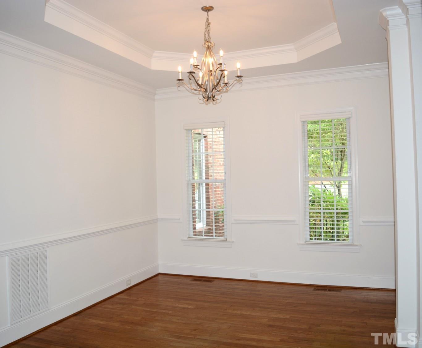 1322 Medfield Road Raleigh, NC 27607 - Photo 6 of 25 a view of an empty room with wooden floor and a window