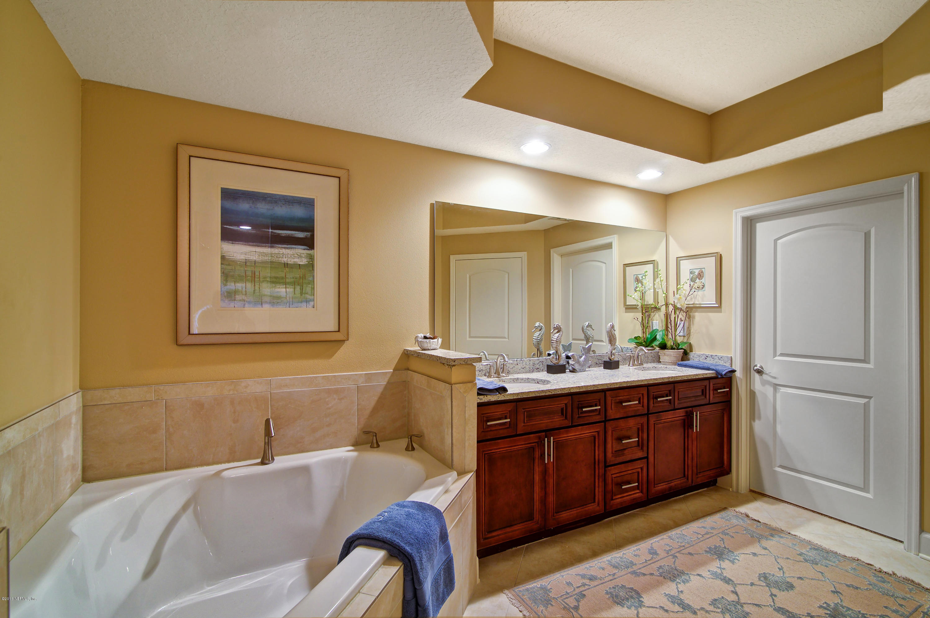3958 Baymeadows Road, Unit 4402 Jacksonville, FL 32217 - Photo 12 of 14 a living room with a bed and furniture