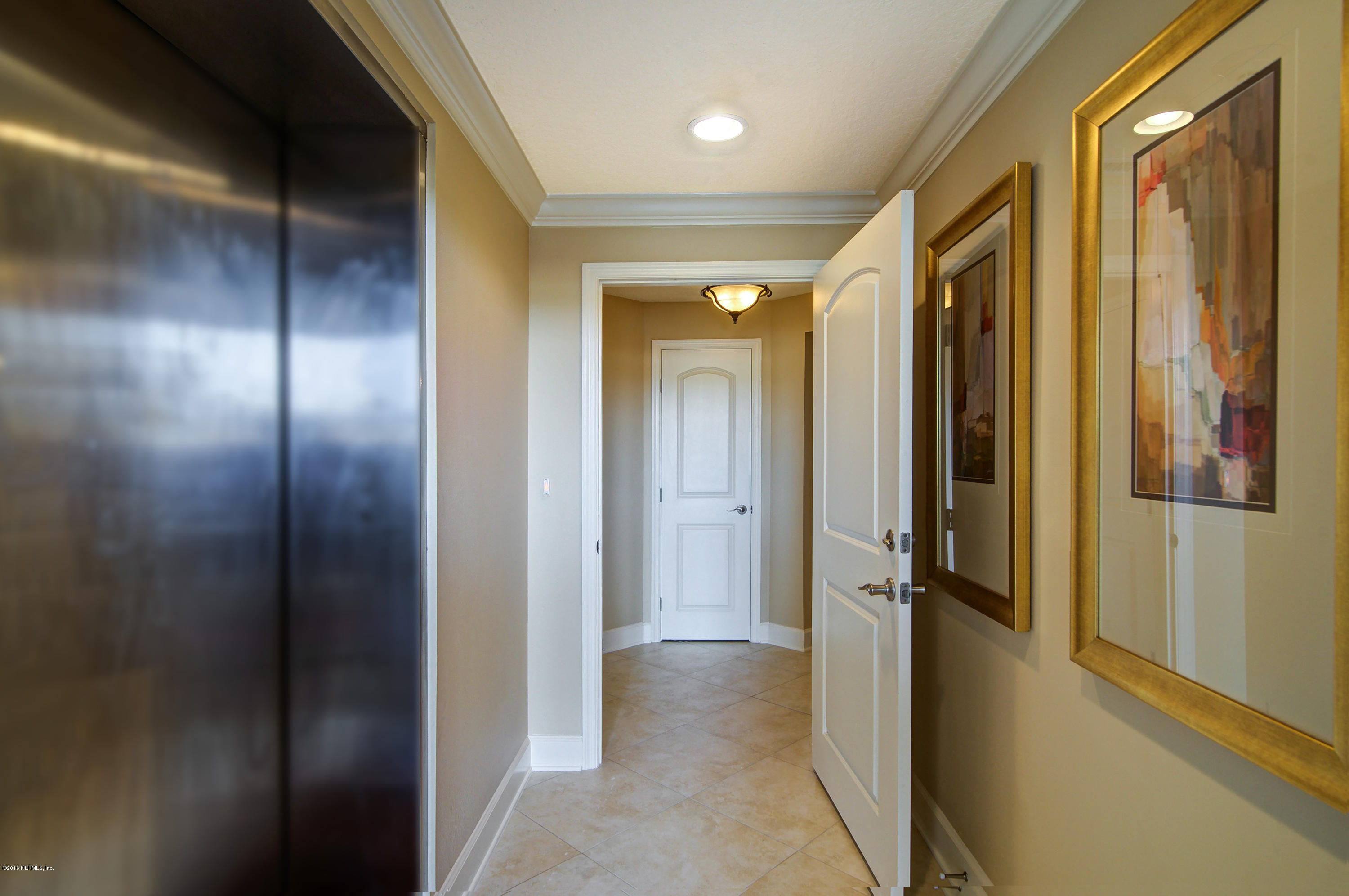 3958 Baymeadows Road, Unit 4402 Jacksonville, FL 32217 - Photo 13 of 14 a view of a hallway with a door and couch