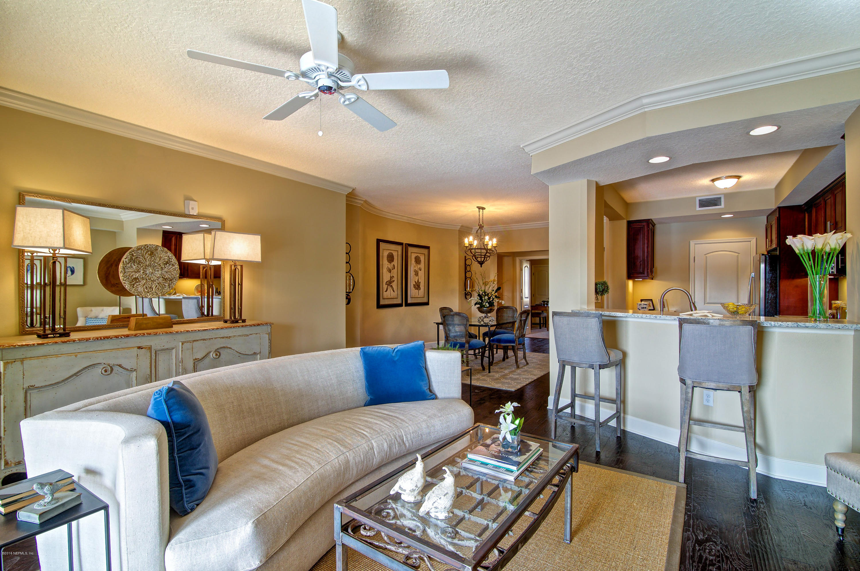 3958 Baymeadows Road, Unit 4402 Jacksonville, FL 32217 - Photo 5 of 14 a living room with furniture a wooden floor and a chandelier