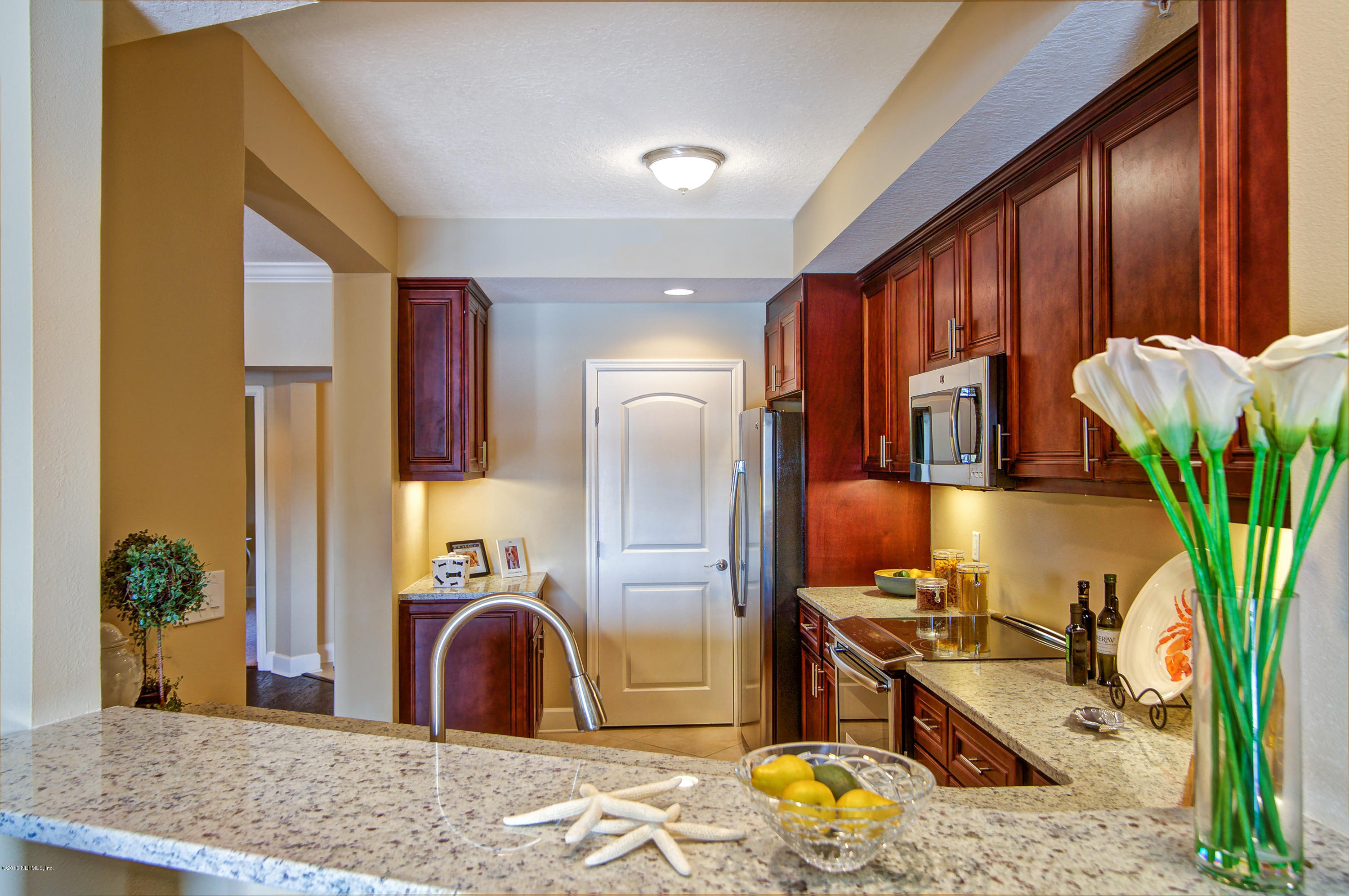 3958 Baymeadows Road, Unit 4402 Jacksonville, FL 32217 - Photo 7 of 14 a bedroom with bed and wooden floor