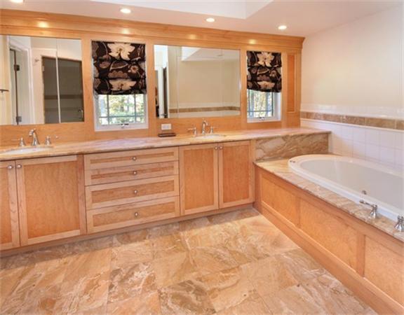 79 Winter Street Lincoln, MA 01773 - Photo 17 of 30 a bathroom with a granite countertop sink and a large mirror
