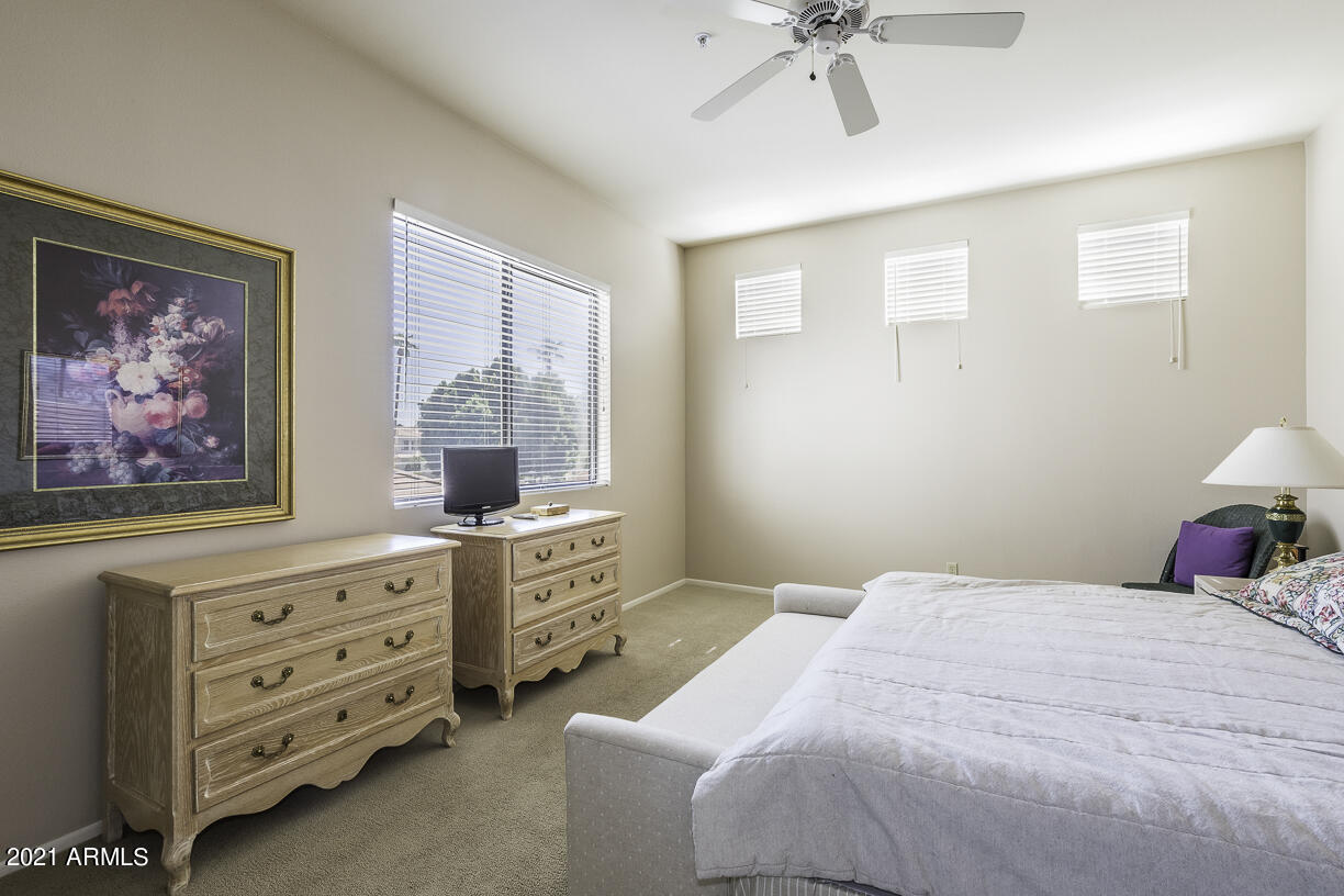 8270 North Hayden Road, Unit 2019 Scottsdale, AZ 85258 - Photo 16 of 39 a bedroom with a bed and a chandelier