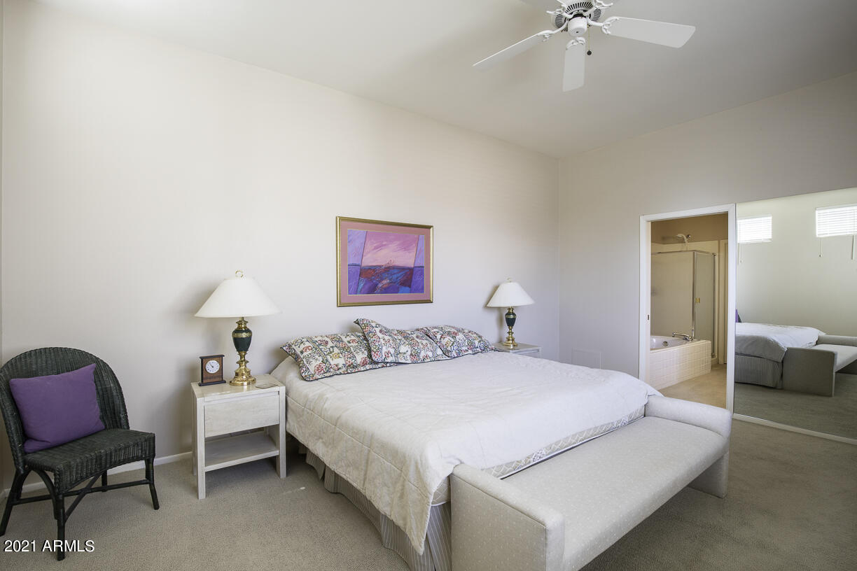 8270 North Hayden Road, Unit 2019 Scottsdale, AZ 85258 - Photo 17 of 39 a bedroom with a bed and a chair