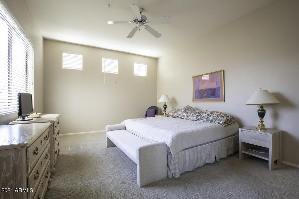 8270 North Hayden Road, Unit 2019 Scottsdale, AZ 85258 - Photo 18 of 39 a spacious bedroom with a bed and a table