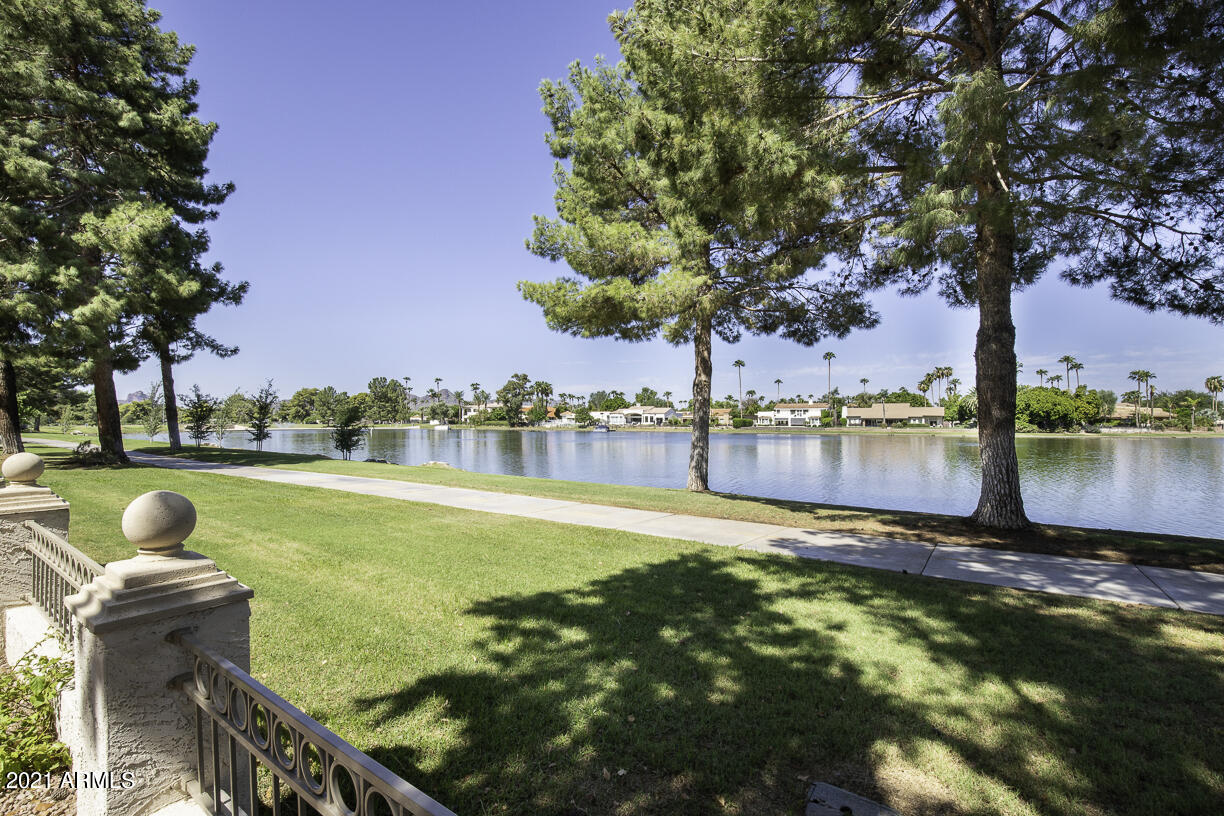 8270 North Hayden Road, Unit 2019 Scottsdale, AZ 85258 - Photo 37 of 39 a view of a lake with a yard and trees
