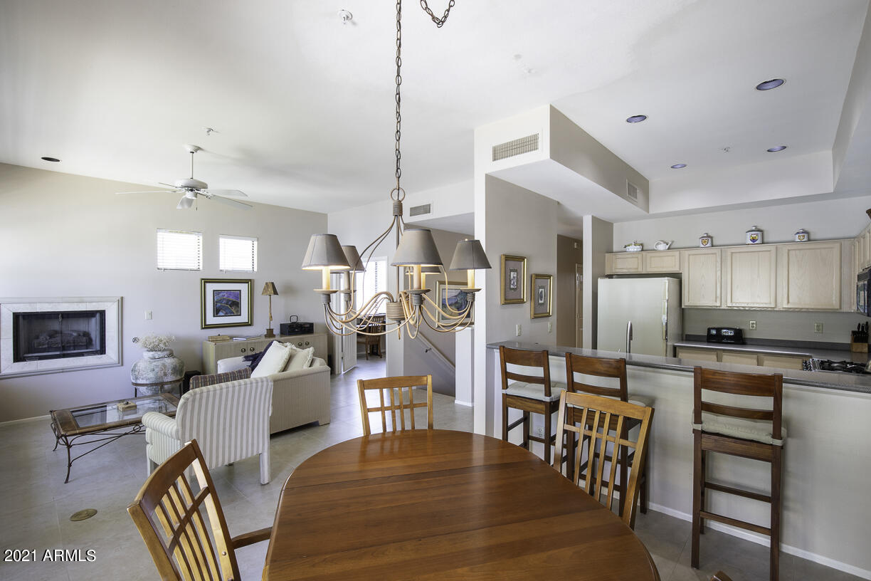 8270 North Hayden Road, Unit 2019 Scottsdale, AZ 85258 - Photo 4 of 39 a living room with stainless steel appliances kitchen island granite countertop furniture and a kitchen view