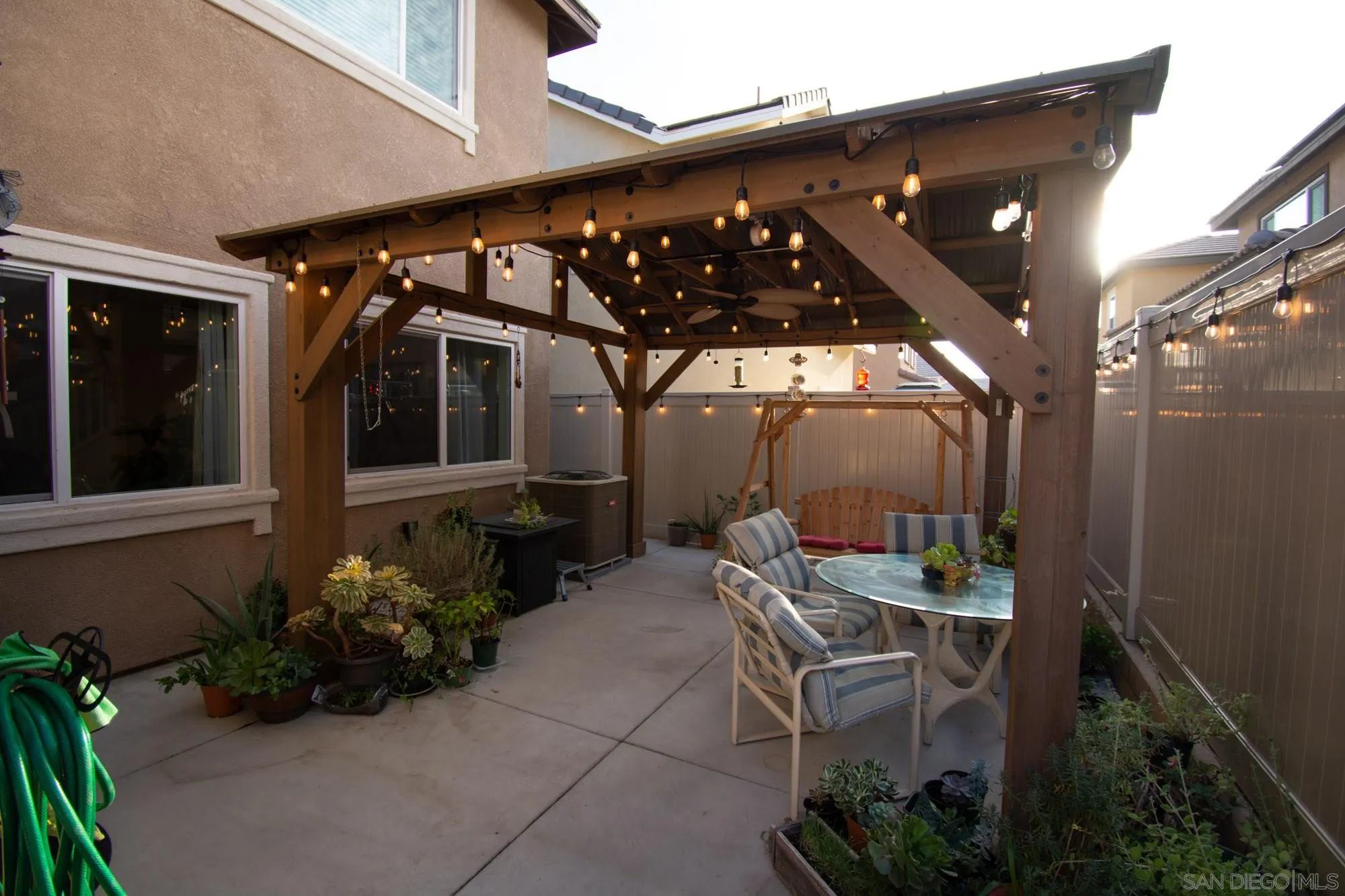 228 Oberlander Way Fallbrook, CA 92028 - Photo 20 of 23 a patio with table and chairs and potted plants