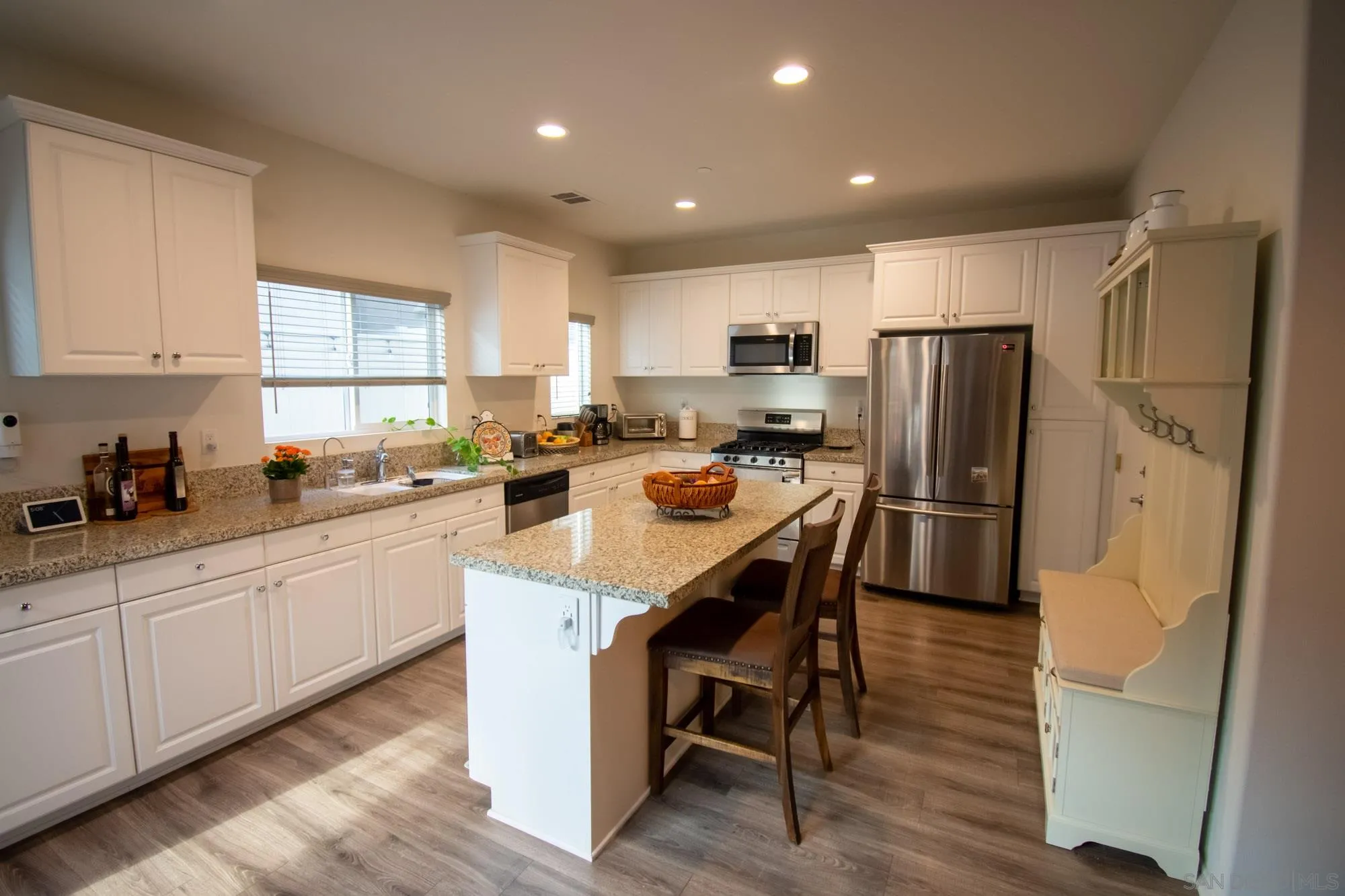 228 Oberlander Way Fallbrook, CA 92028 - Photo 5 of 23 a kitchen with stainless steel appliances a refrigerator sink and wooden cabinets