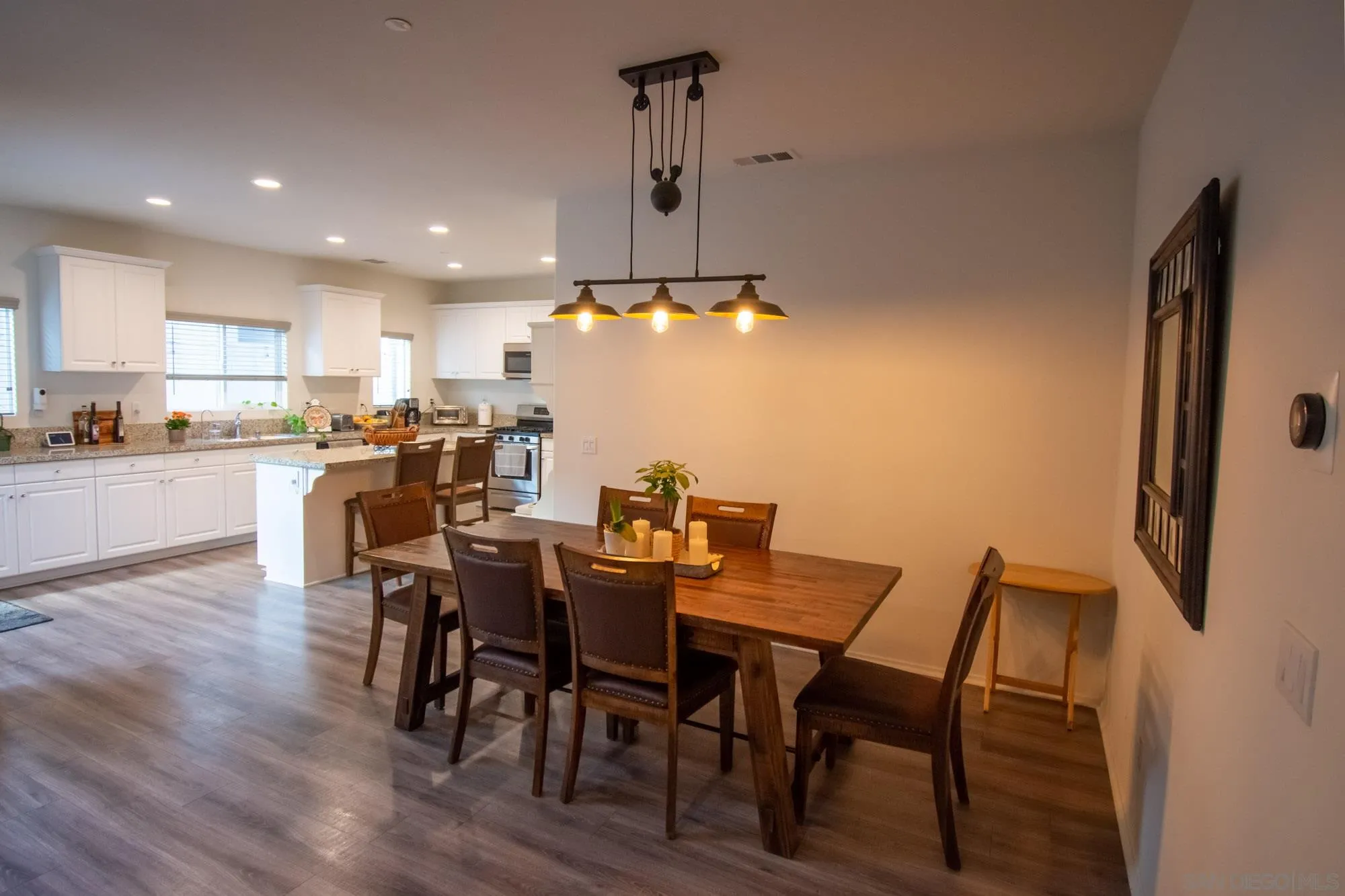 228 Oberlander Way Fallbrook, CA 92028 - Photo 6 of 23 a view of a dining room with furniture and wooden floor