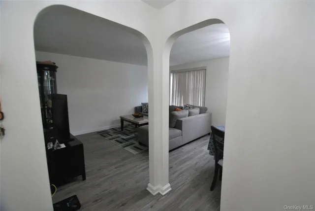 a view of a livingroom with wooden floor and furniture