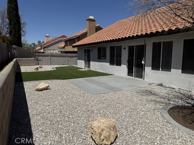 12590 Cobalt Road Victorville, CA 92392 - Photo 6 of 37 a front view of a house with a garden and yard