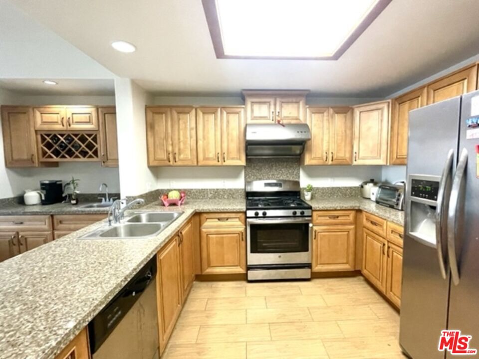 11 South 3rd Street, Unit 502 Alhambra, CA 91801 - Photo 20 of 33 a kitchen with stainless steel appliances granite countertop a sink stove and refrigerator