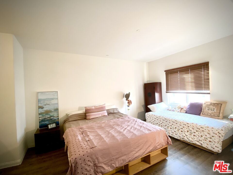 11 South 3rd Street, Unit 502 Alhambra, CA 91801 - Photo 23 of 33 a bedroom with two beds and a lamp