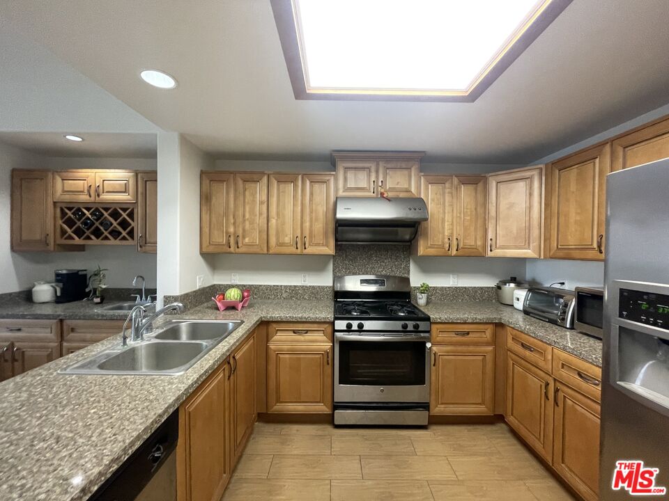 11 South 3rd Street, Unit 502 Alhambra, CA 91801 - Photo 28 of 33 a kitchen with a sink stove top oven and refrigerator