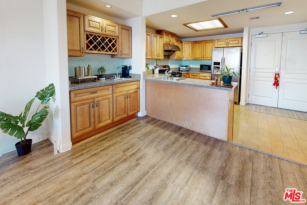 11 South 3rd Street, Unit 502 Alhambra, CA 91801 - Photo 7 of 33 a kitchen with a sink a counter top space and cabinets