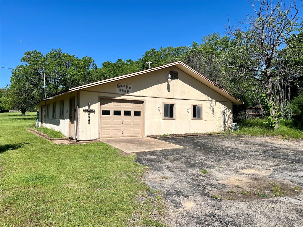 200 South Ash Avenue Azle, TX 76020 - Photo 1 of 1 a front view of a house with a garden