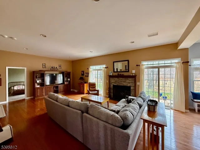 a living room with fireplace furniture and a wooden floor