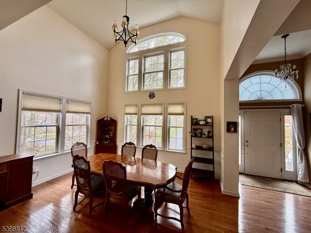 a view of a a dining room with furniture window and wooden floor