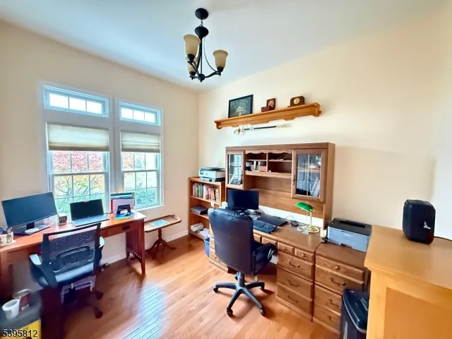 a view of a workspace with furniture hardwood and a workspace