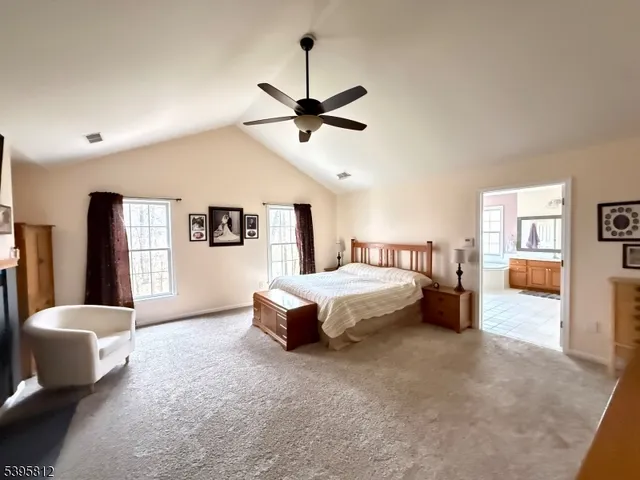 a spacious bedroom with a bed a couch and a dresser