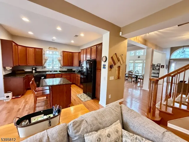 a living room with furniture kitchen view and a large window