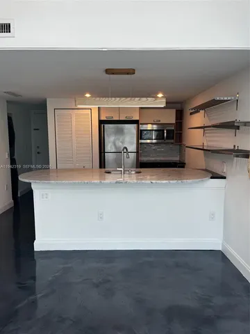a view of a kitchen with a sink and cabinets