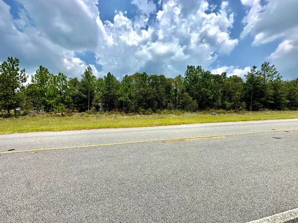 a view of a swimming pool and mountains in the background