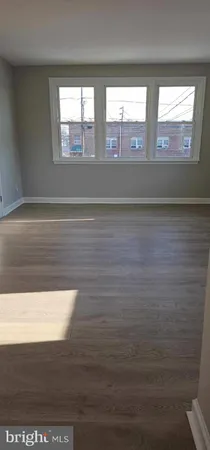 a view of wooden floor and windows in a room