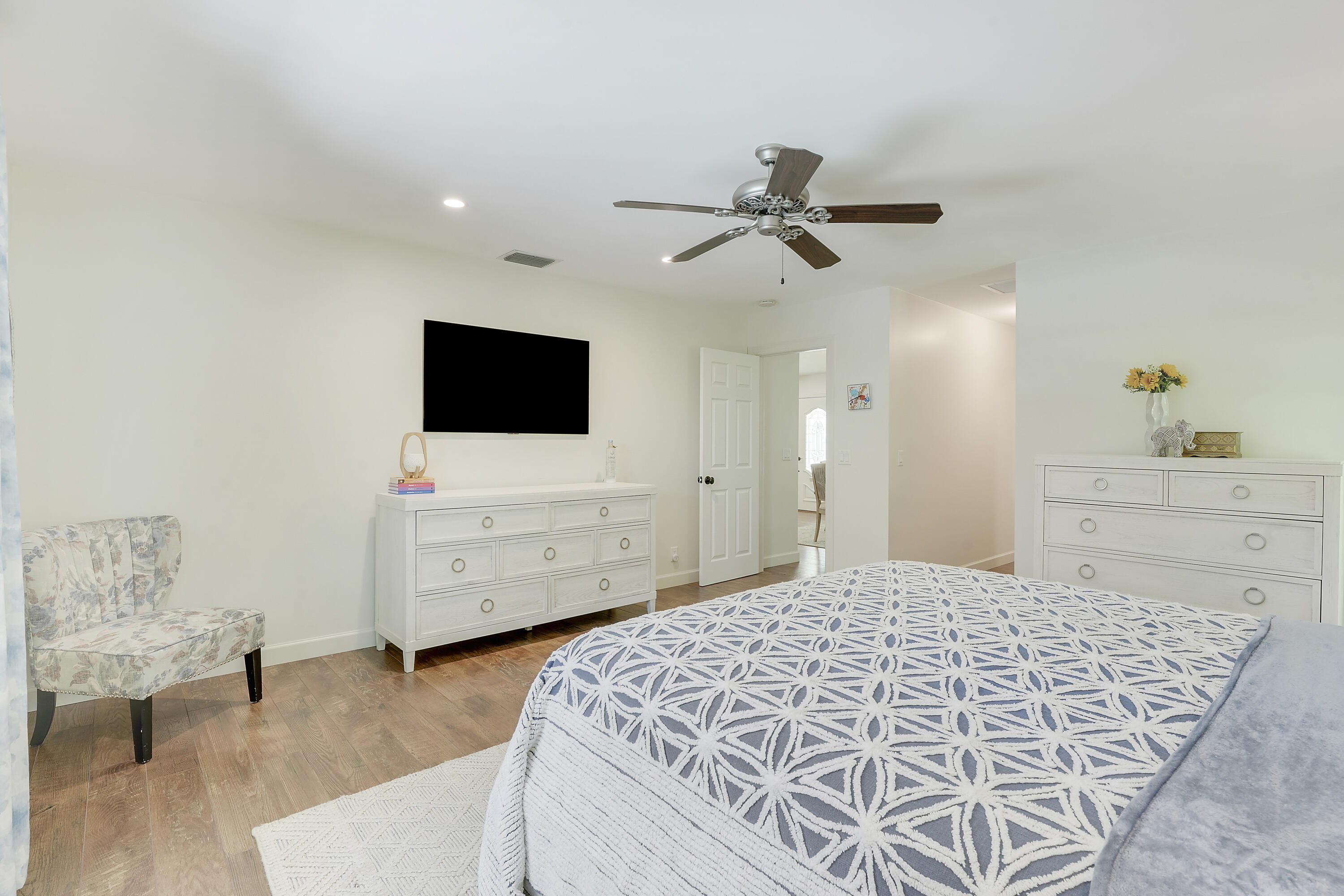 18784 Falcon Way Jupiter, FL 33458 - Photo 18 of 47 a bedroom with a bed and flat screen tv