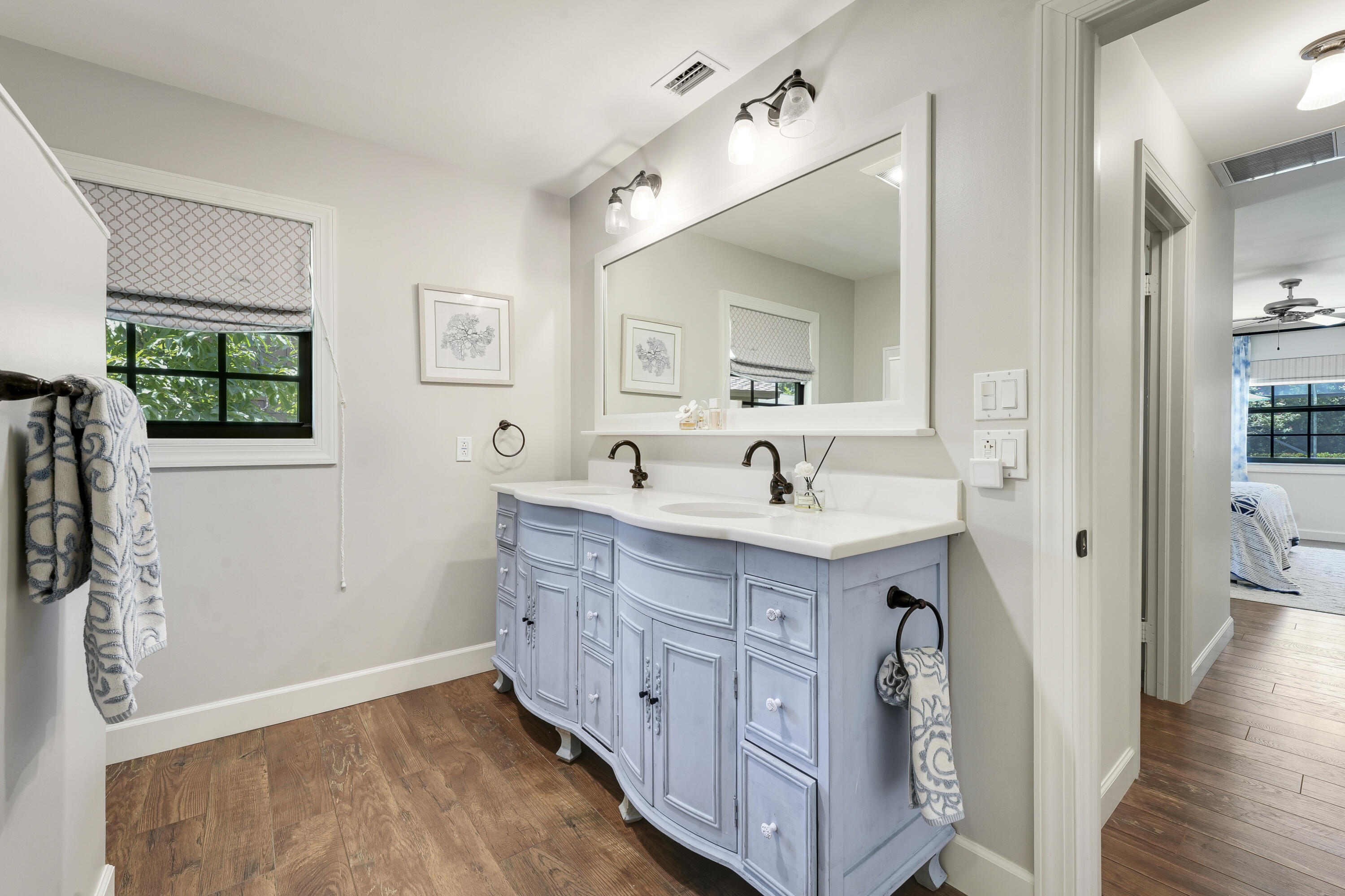 18784 Falcon Way Jupiter, FL 33458 - Photo 22 of 47 a spacious bathroom with a double vanity sink a mirror and a shower