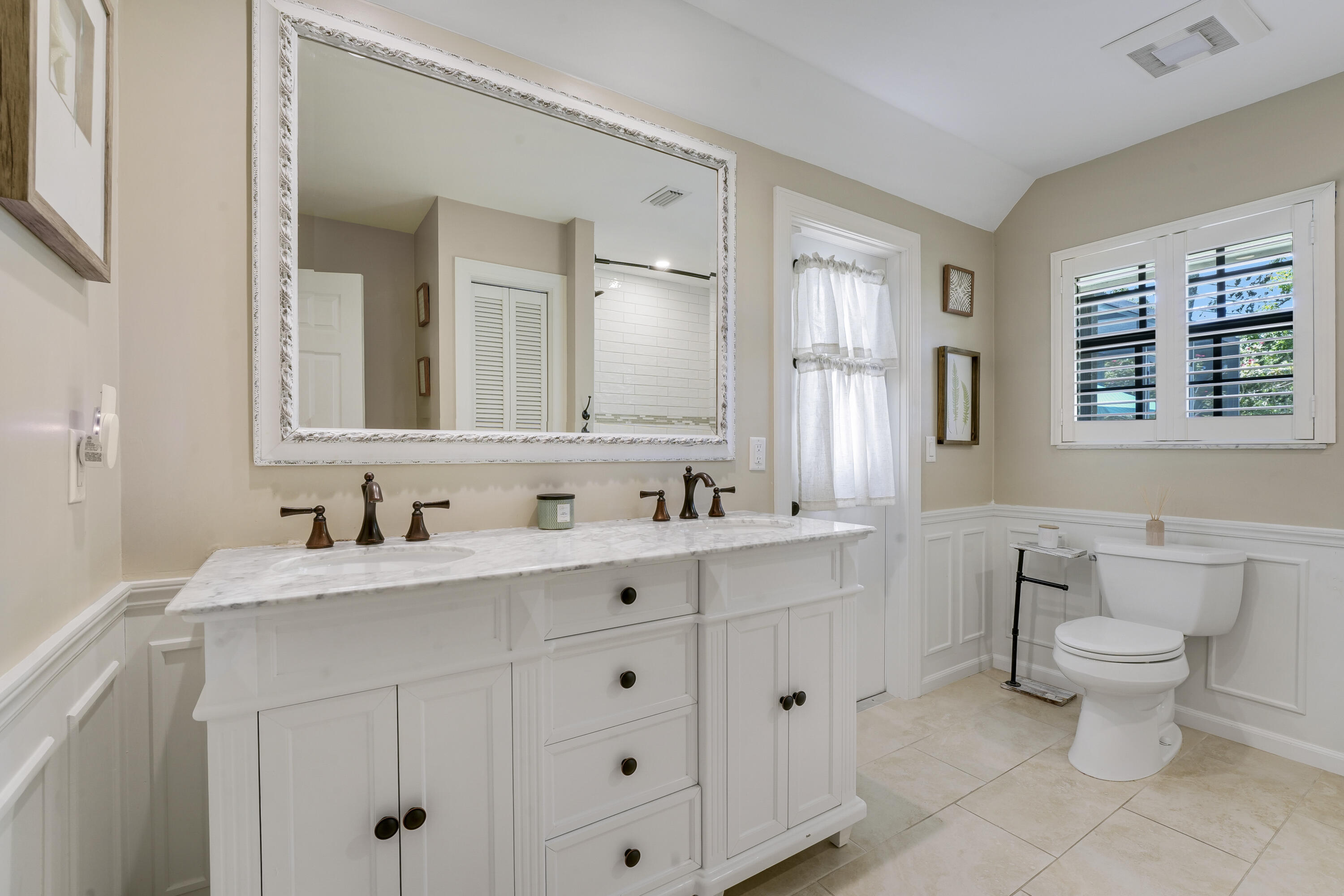 18784 Falcon Way Jupiter, FL 33458 - Photo 24 of 47 a bathroom with a toilet sink and mirror