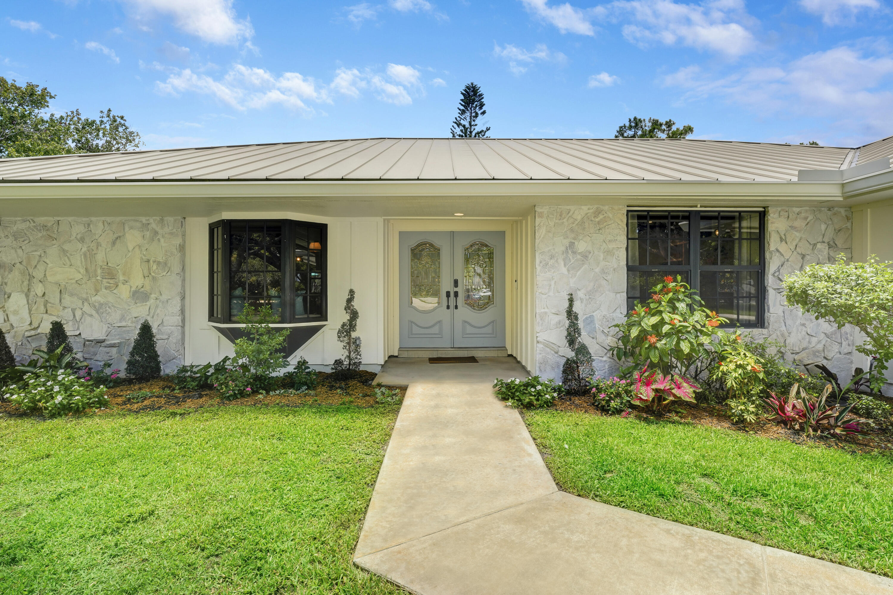 18784 Falcon Way Jupiter, FL 33458 - Photo 3 of 47 a view of a house with garden