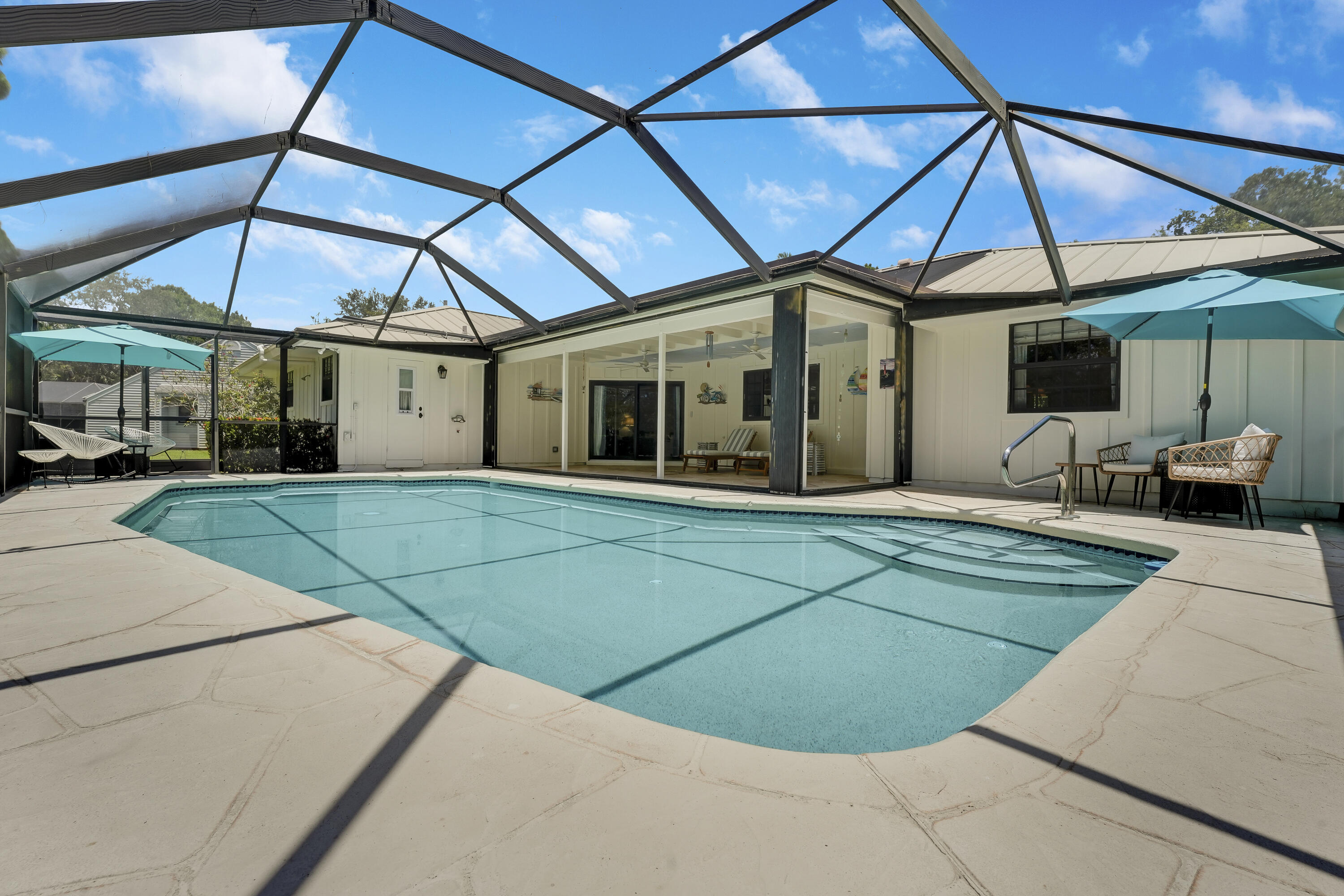18784 Falcon Way Jupiter, FL 33458 - Photo 32 of 47 a view of a white house with a big yard potted plants and a chair