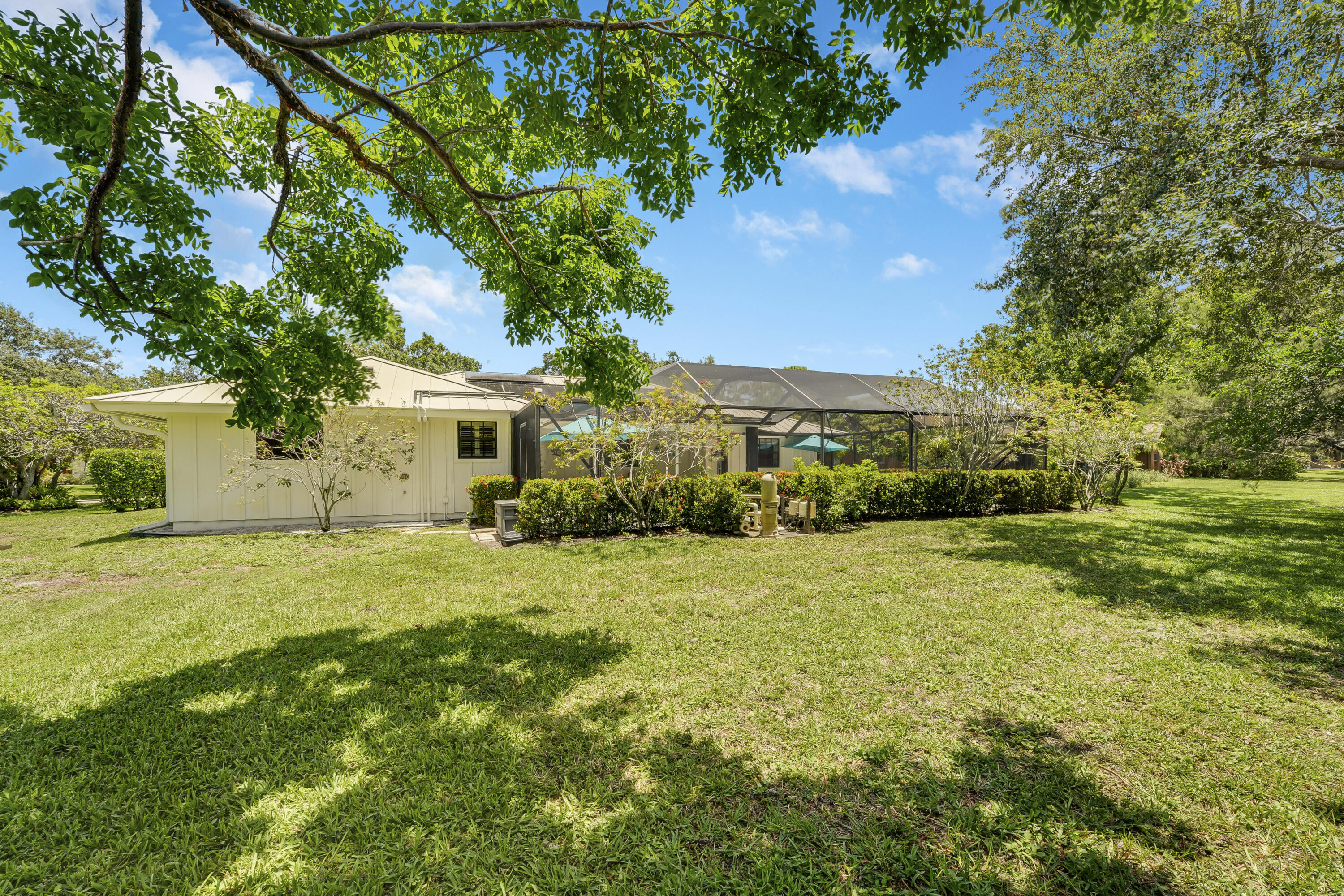 18784 Falcon Way Jupiter, FL 33458 - Photo 34 of 47 a front view of a house with a yard and trees